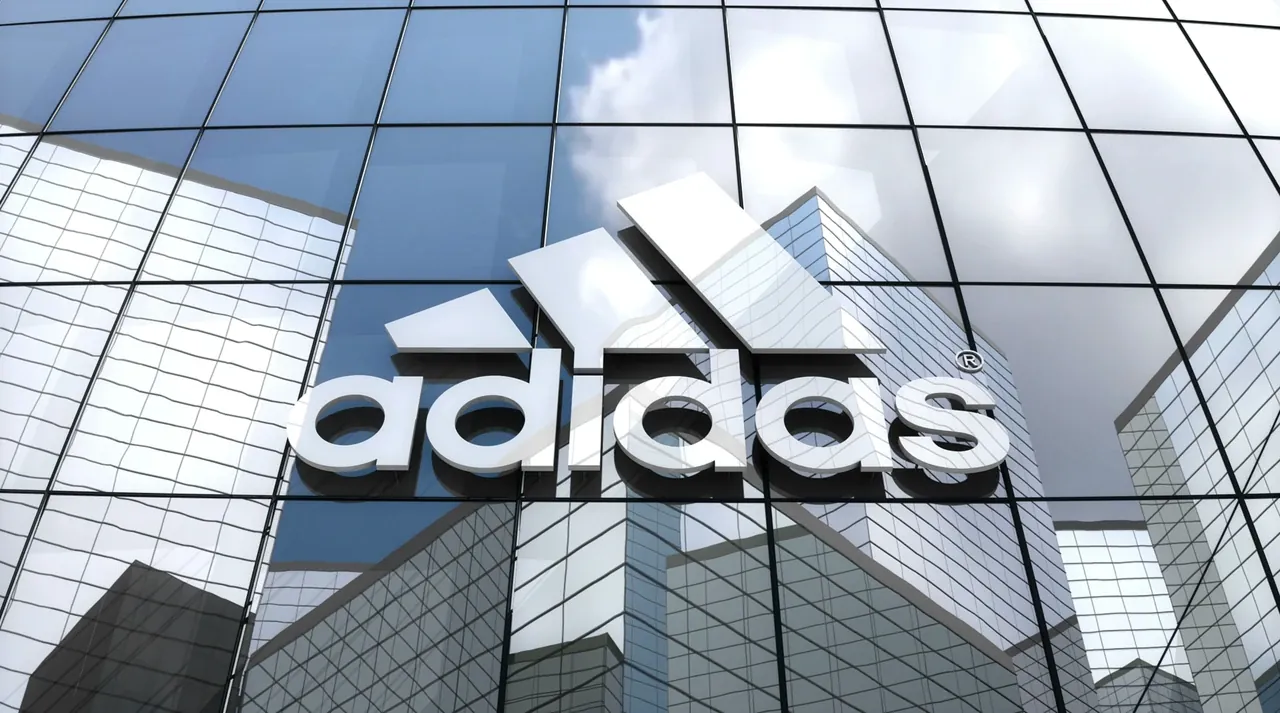 adidas logo on a glass office façade